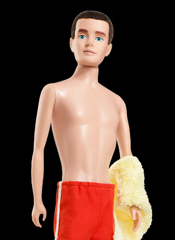 1961 Ken doll in red swim shorts and a yellow towel with a blond short-cropped hairstyle