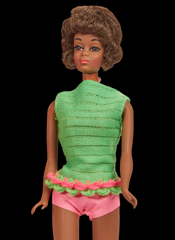 1968 Christie doll with a short brown bob hairstyle and gold hoop earrings in a green knit top